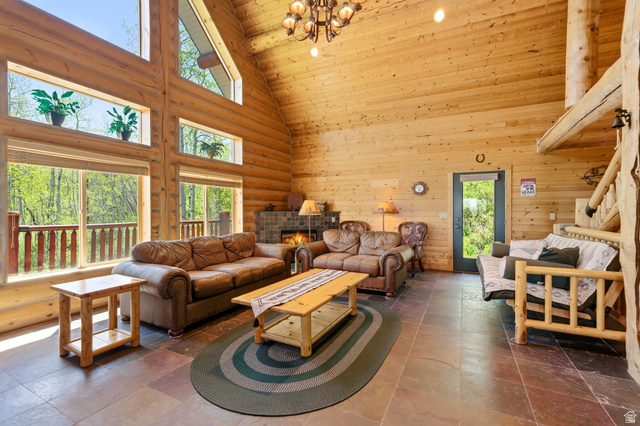 2096 South Aspen Ridge Coalville, UT 84017 - Photo 11 of 44 Vaulted wood-paneled ceiling with exposed log beams and a wrought iron chandelier