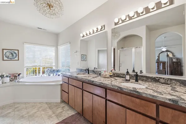 a bathroom with a double vanity sink and a mirror