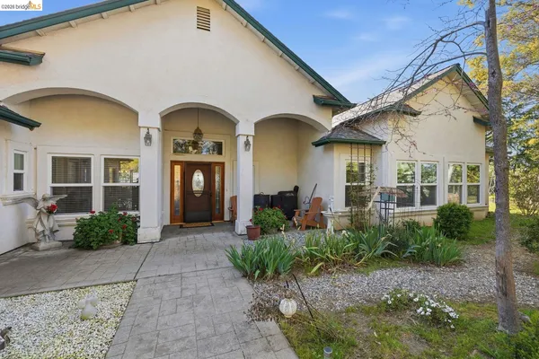 a front view of a house with garden
