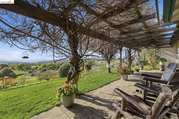 a view of a backyard with sitting area