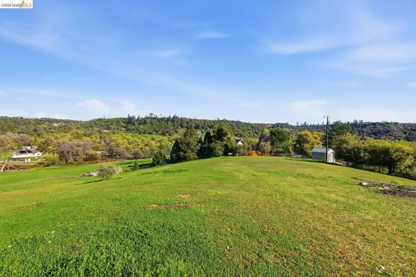 a view of a big yard with an outdoor space and seating area