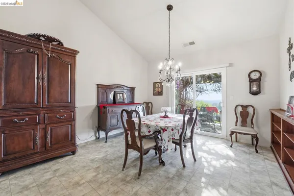 a view of a dining room with furniture and chandelier