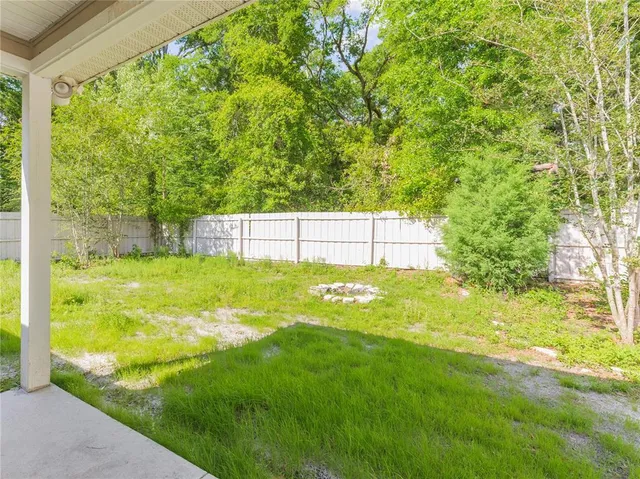 a view of yard with swimming pool and green space
