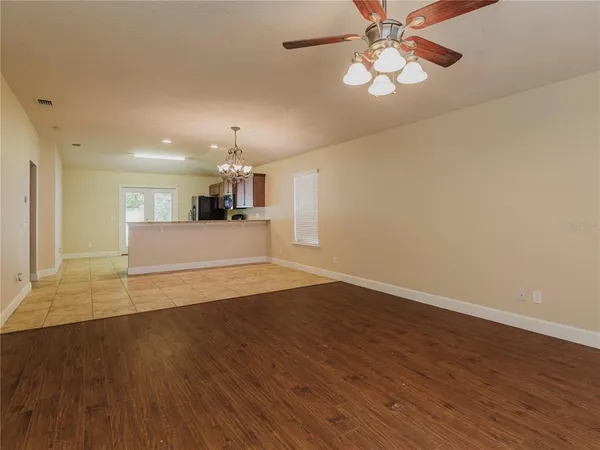 a view of a kitchen with wooden floor and a kitchen space