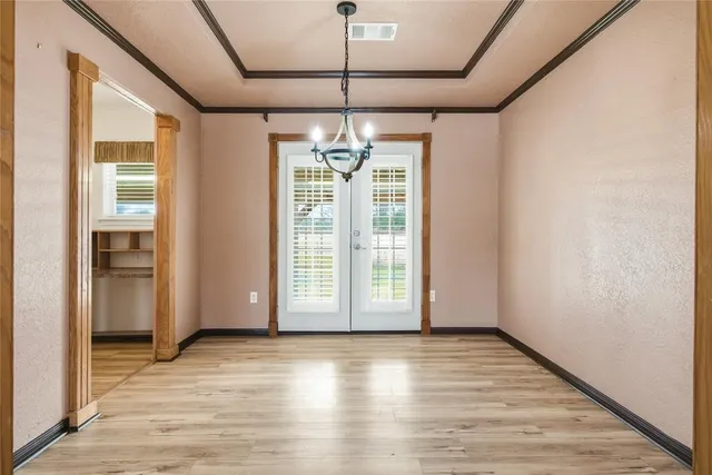 a view of a room with window wooden floor and chandelier