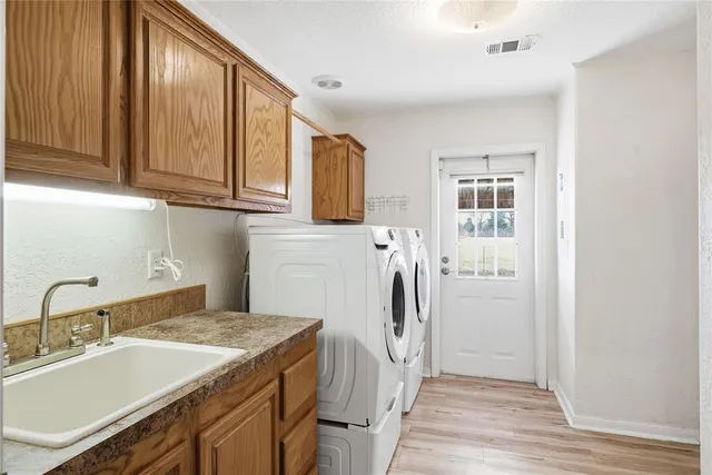 a kitchen with a refrigerator and a sink
