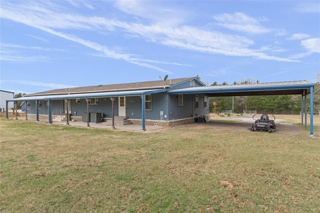 a view of a house with backyard porch and sitting area