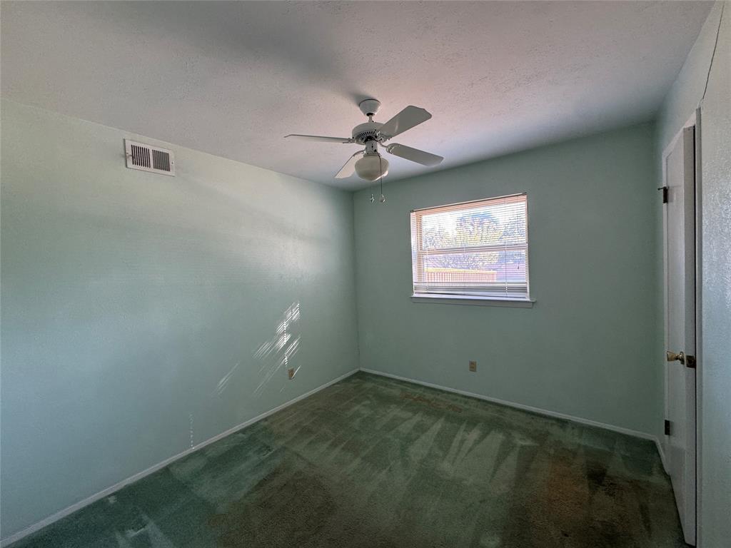 1900 Provincetown Lane Richardson, TX 75080 - Photo 11 of 14 en empty room with ceiling fan and window