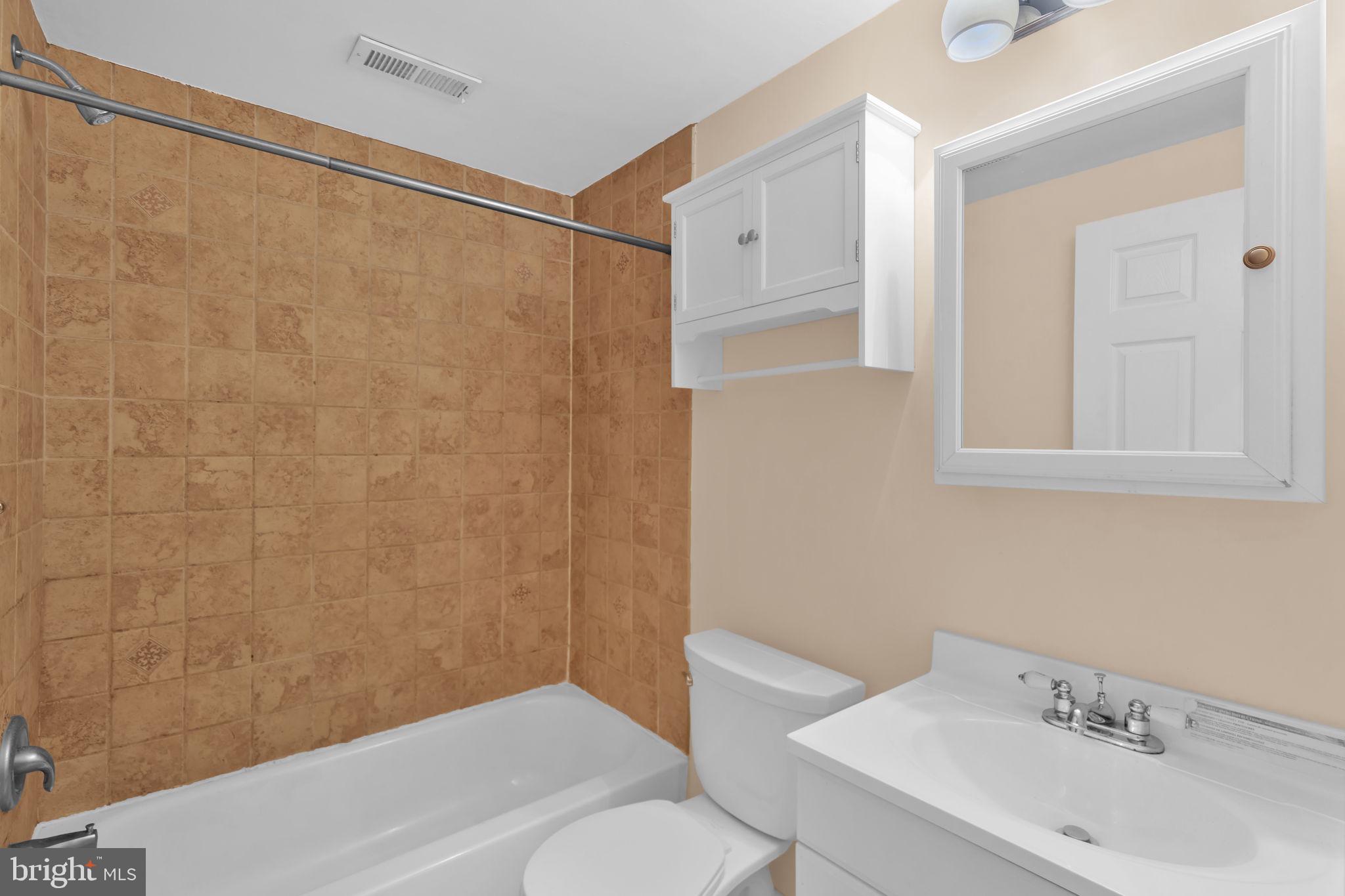 1447 William Street Baltimore, MD 21230 - Photo 17 of 65 a bathroom with a sink toilet and shower