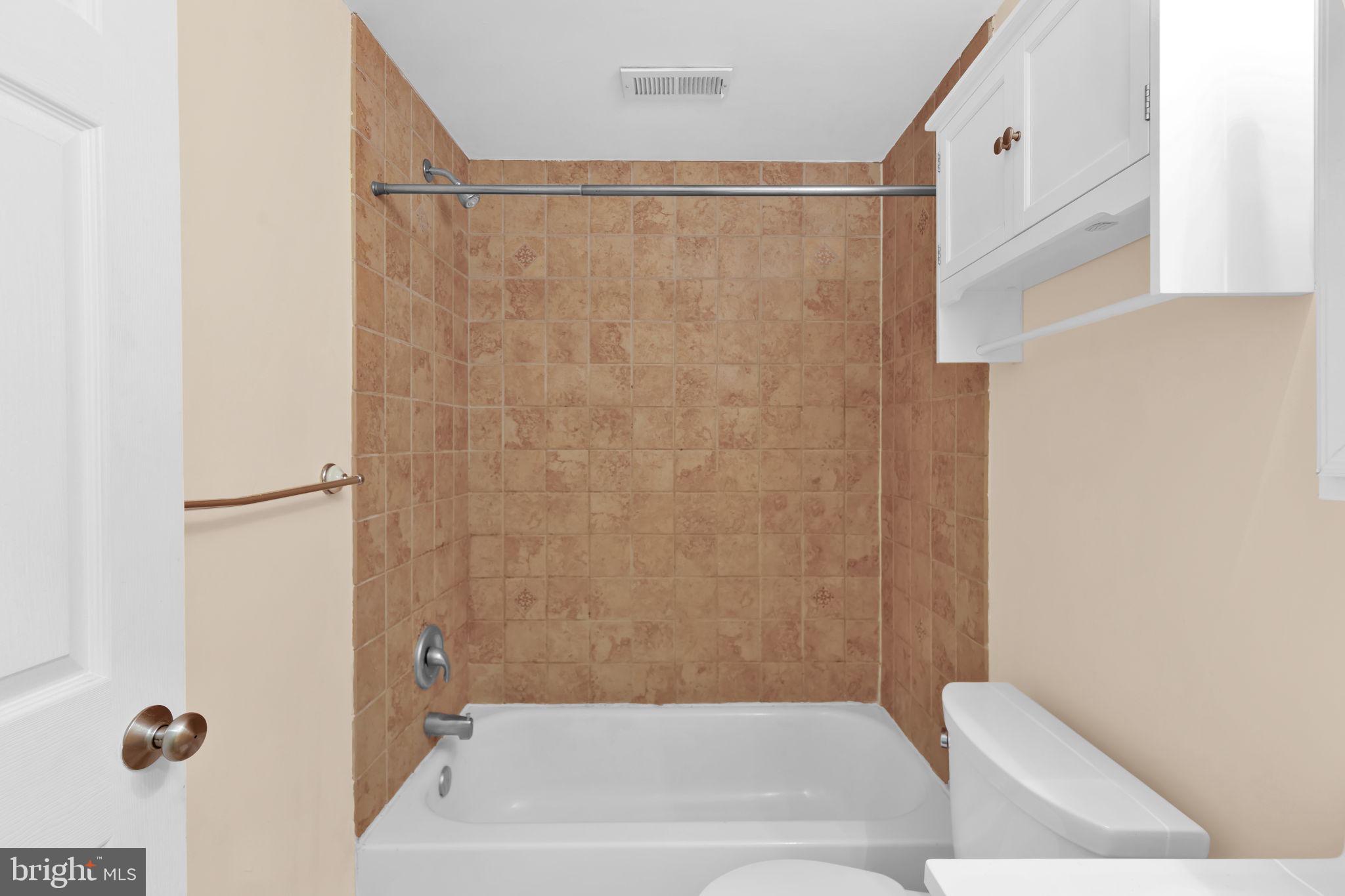 1447 William Street Baltimore, MD 21230 - Photo 19 of 65 a bathroom with a bathtub and a shower