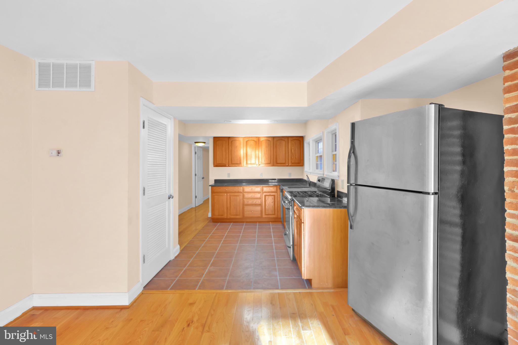 1447 William Street Baltimore, MD 21230 - Photo 29 of 65 a kitchen with a refrigerator a sink and a stove top oven
