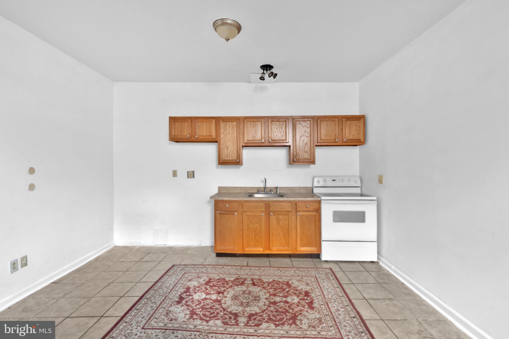 1447 William Street Baltimore, MD 21230 - Photo 51 of 65 a kitchen with stainless steel appliances granite countertop a sink stove and cabinets