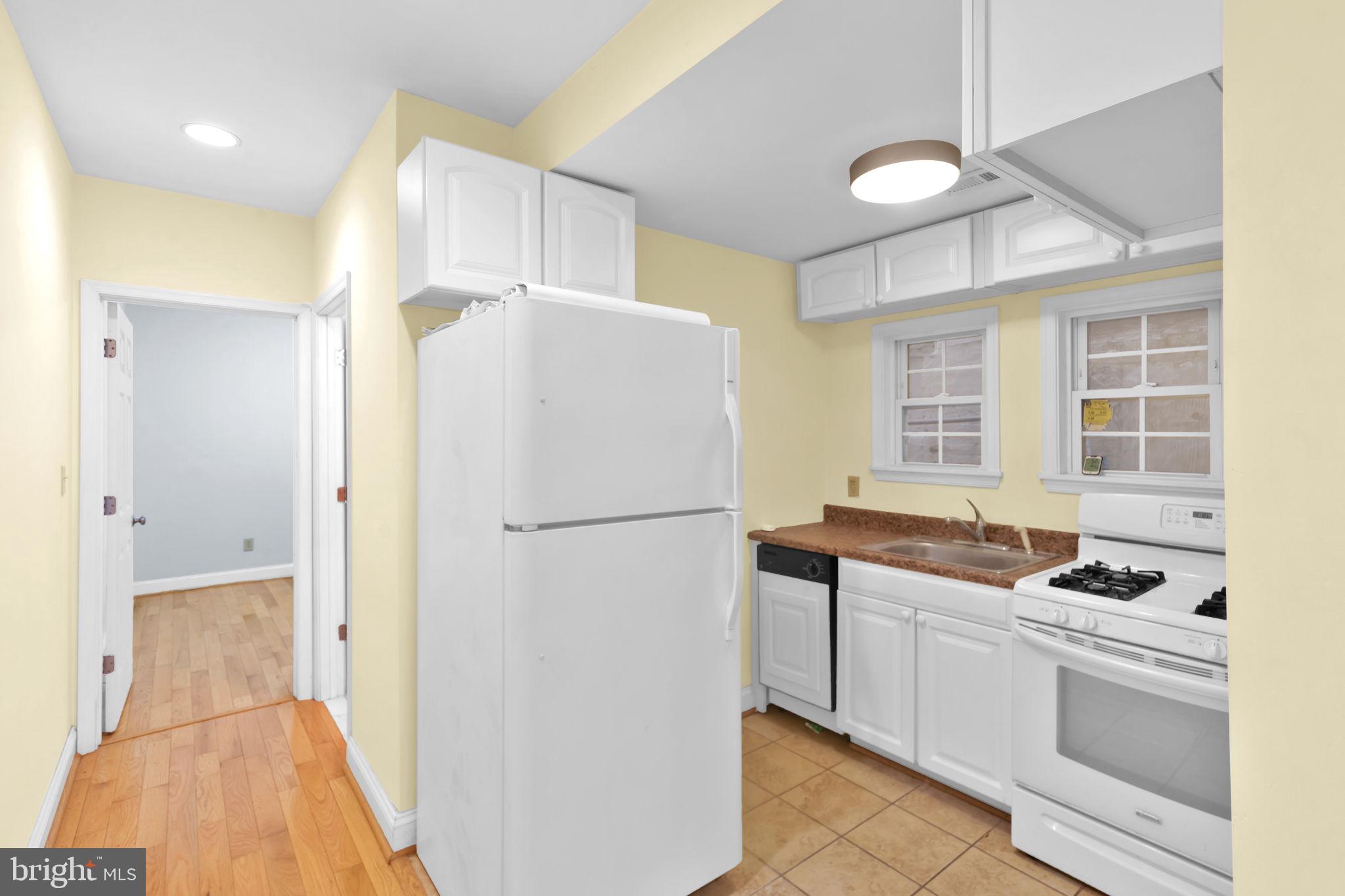 1447 William Street Baltimore, MD 21230 - Photo 10 of 65 a white refrigerator freezer sitting inside of a kitchen