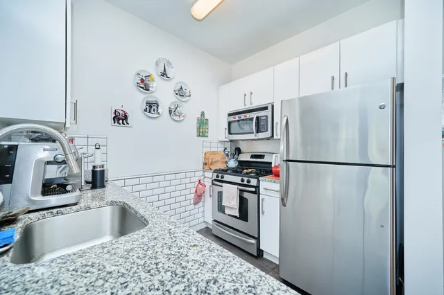 a kitchen with a refrigerator and microwave