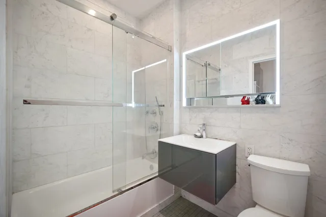 a bathroom with a sink toilet and shower