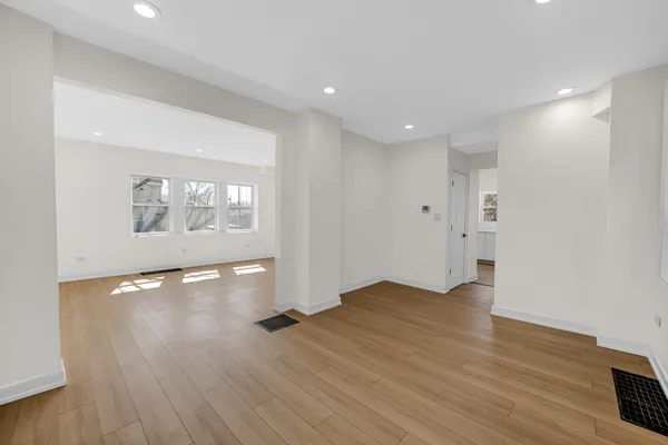 a kitchen with stainless steel appliances a refrigerator and wooden floor