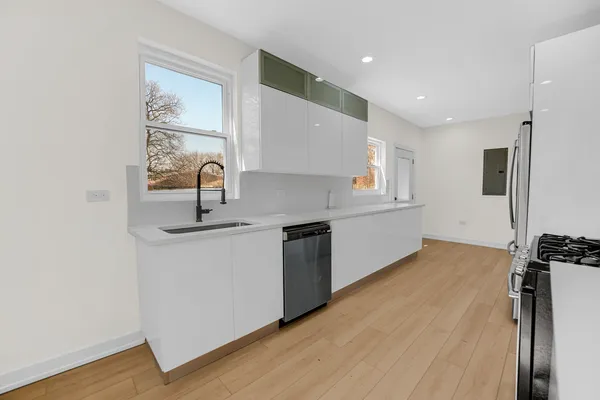 a kitchen with stainless steel appliances a refrigerator and a stove top oven
