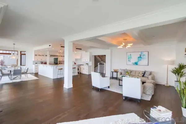 a living room with furniture and view of kitchen