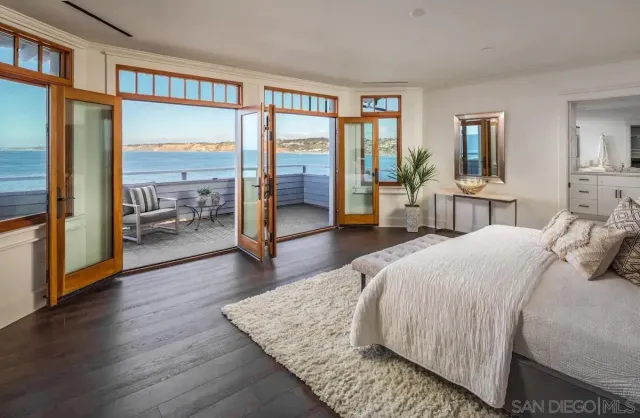 a bedroom with a large bed and a large window