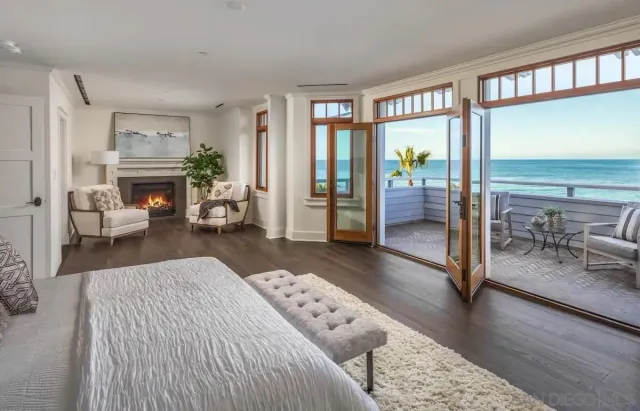 a bedroom with furniture and a large window