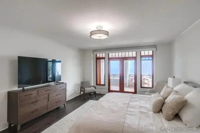 a bedroom with furniture and a flat screen tv