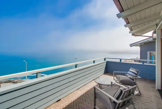 a balcony with chairs and with plants