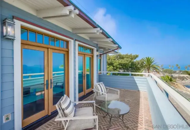 a view of a chairs and table in a balcony