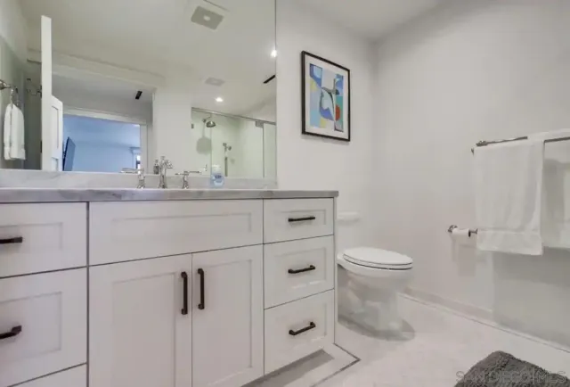 a bathroom with a shower sink and mirror