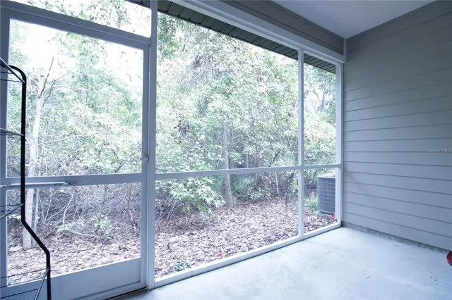 a view of a room with a window and front door