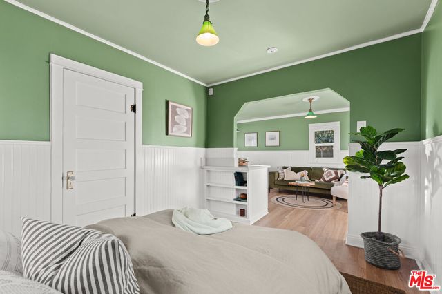 a spacious bedroom with a bed and a chandelier