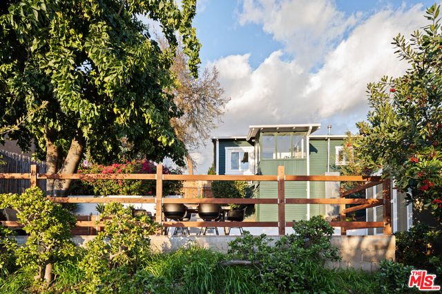a view of a chairs and table on the wooden deck