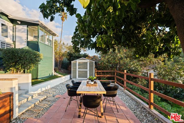 a backyard of a house with table and chairs