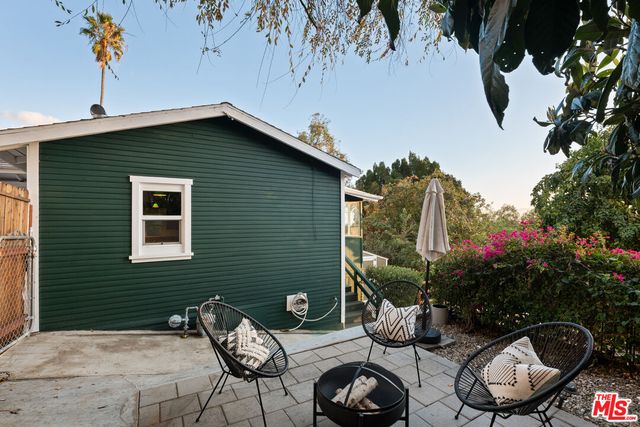 a backyard of a house with table and chairs