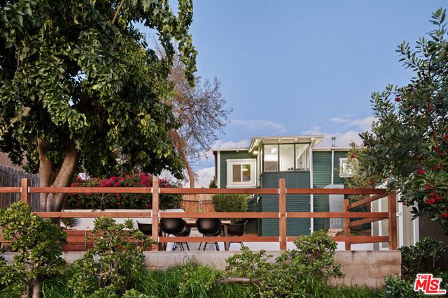 a table and chairs sitting in front of a house