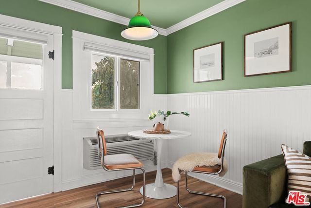 a large living room with stainless steel appliances kitchen island granite countertop a couch and a flat screen tv