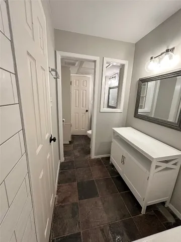 a bathroom with a sink a mirror and a toilet