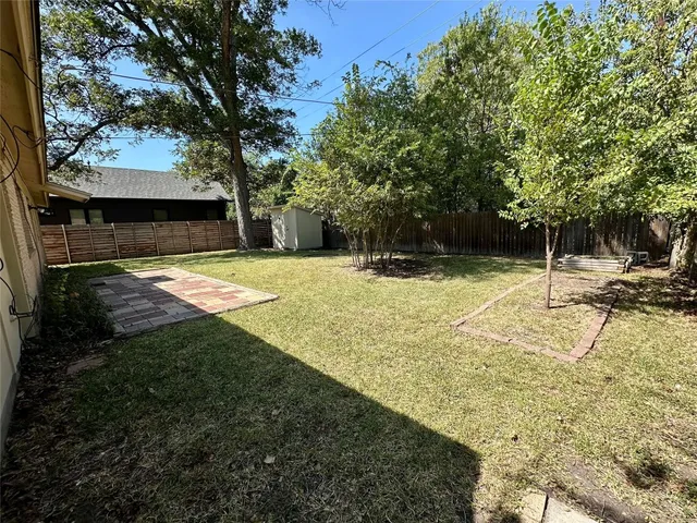 a view of yard with swimming pool and seating space