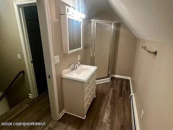 a bathroom with a sink and mirror