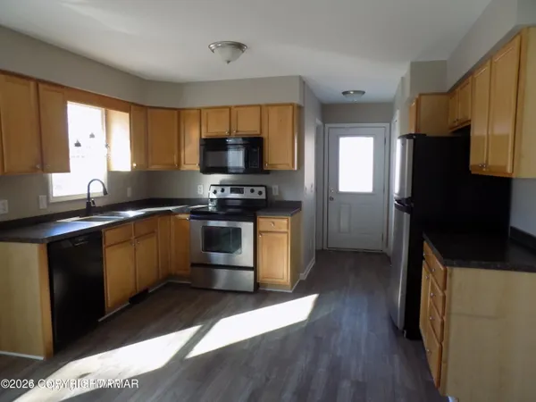 a kitchen with a sink stove and refrigerator