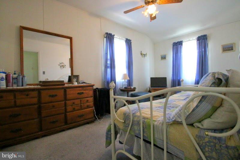 1904 Nevill Road Baltimore, MD 21222 - Photo 17 of 30 a bedroom with a bed and a chandelier