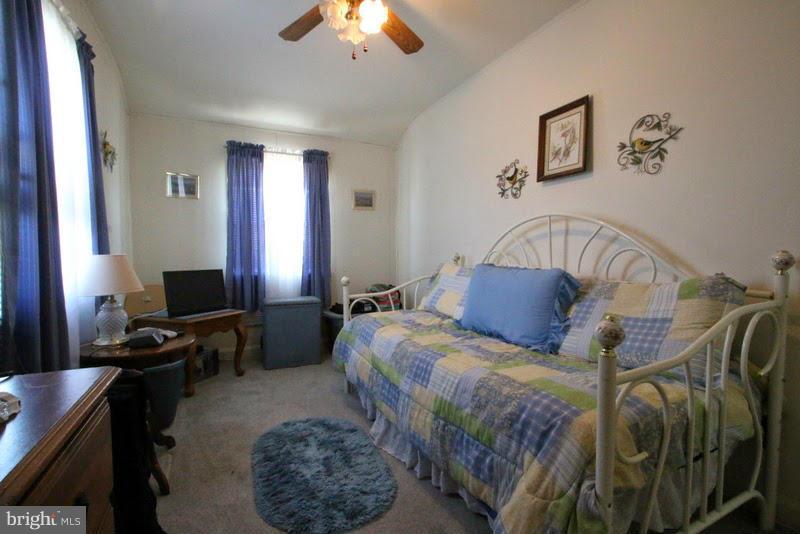 1904 Nevill Road Baltimore, MD 21222 - Photo 20 of 30 a bedroom with a bed and a chandelier
