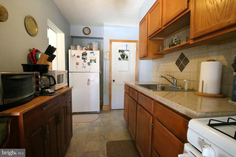 1904 Nevill Road Baltimore, MD 21222 - Photo 9 of 30 a kitchen with stainless steel appliances granite countertop a sink stove and refrigerator