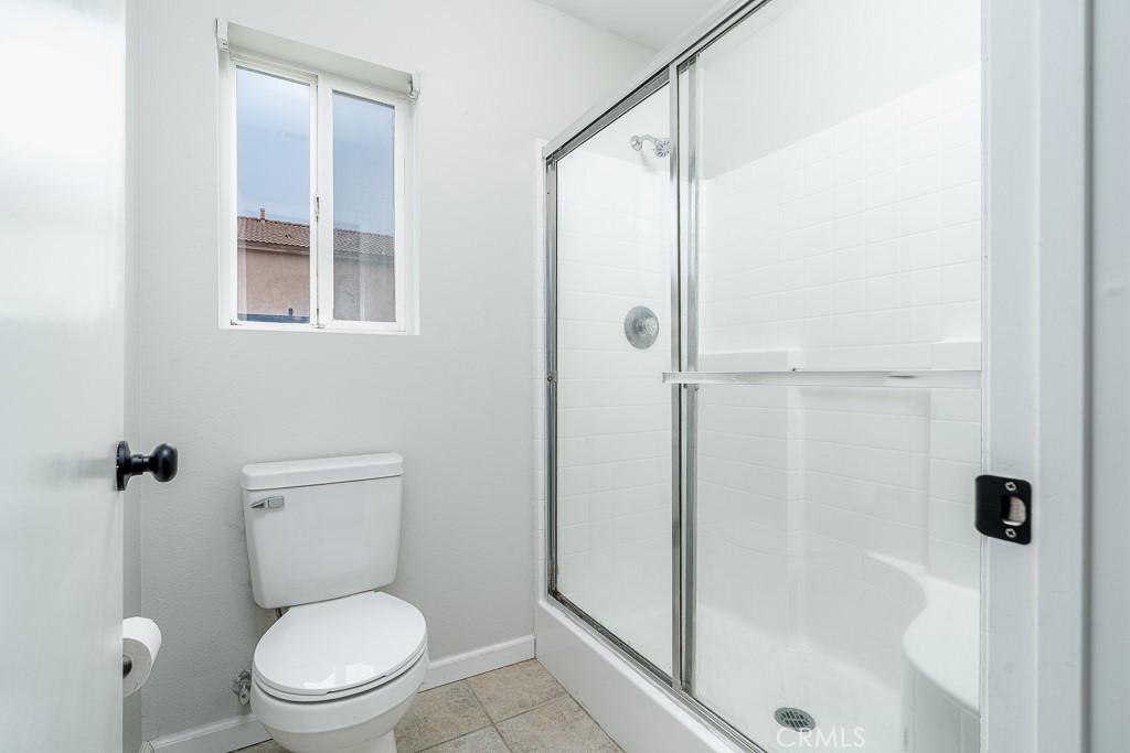 4680 Birchleaf Lane Hemet, CA 92545 - Photo 14 of 34 a bathroom with a toilet and shower