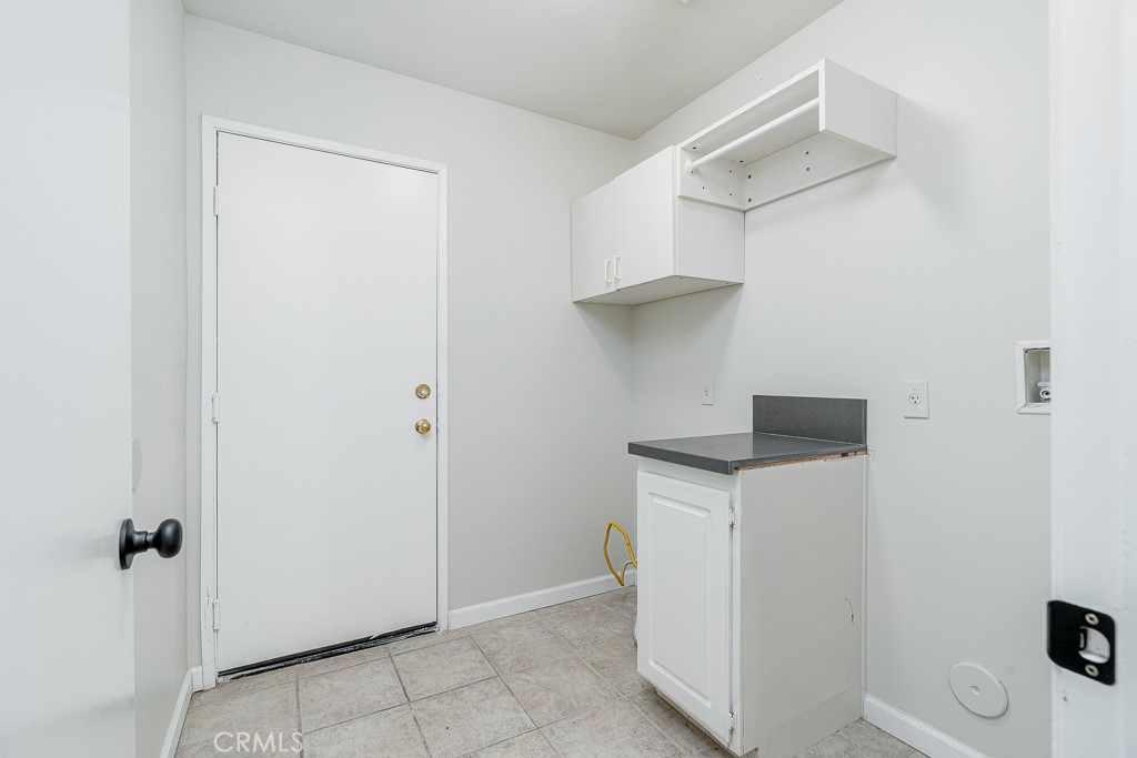 4680 Birchleaf Lane Hemet, CA 92545 - Photo 16 of 34 a utility room with cabinets washer and dryer