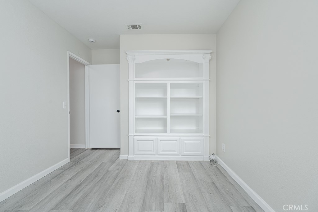 4680 Birchleaf Lane Hemet, CA 92545 - Photo 18 of 34 a view of an empty room with wooden floor and closet