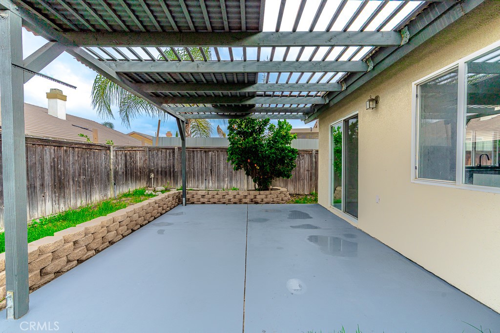 4680 Birchleaf Lane Hemet, CA 92545 - Photo 20 of 34 a view of a porch with a table and chairs under an umbrella