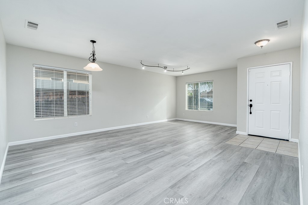 4680 Birchleaf Lane Hemet, CA 92545 - Photo 5 of 34 a view of empty room with wooden floor and window