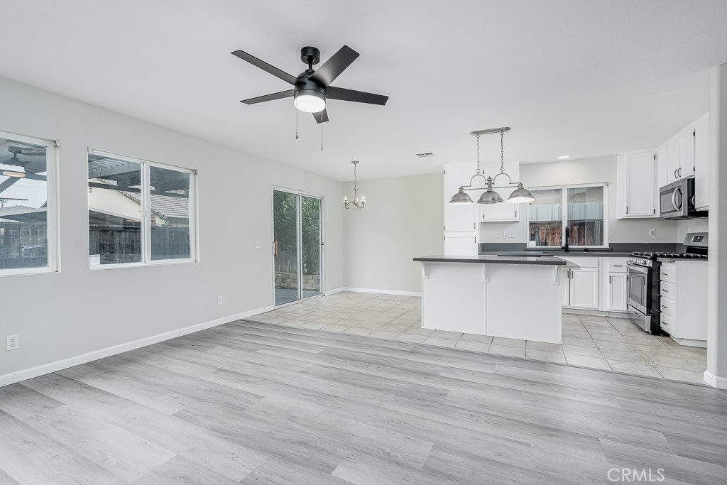 4680 Birchleaf Lane Hemet, CA 92545 - Photo 6 of 34 a view of a kitchen with stainless steel appliances kitchen island wooden floors and living room view