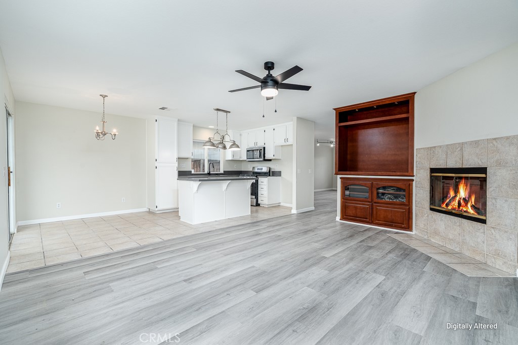 4680 Birchleaf Lane Hemet, CA 92545 - Photo 7 of 34 a view of a kitchen with a sink a microwave and cabinets