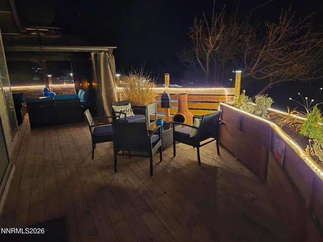 a view of a porch with furniture and a yard